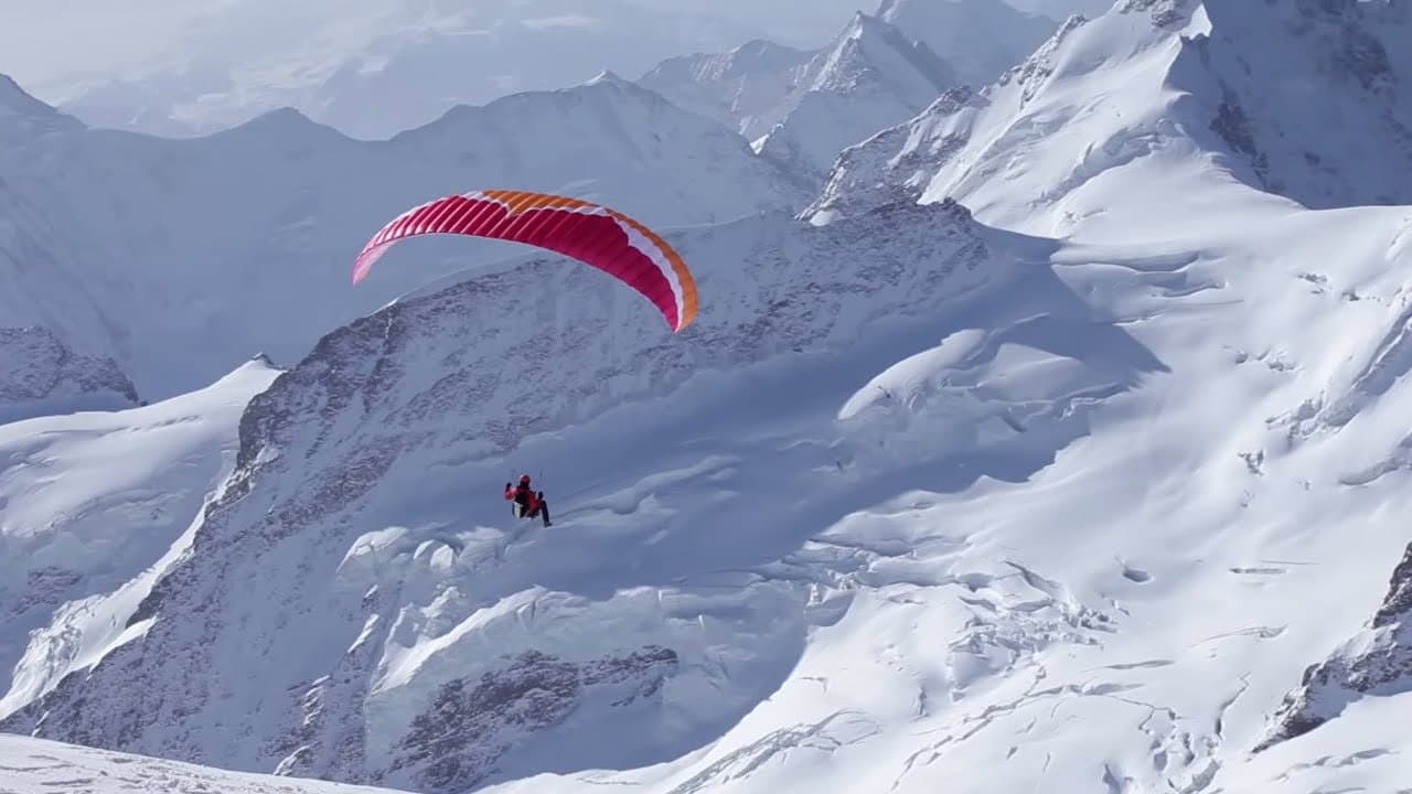 Backdrop – Ueli Steck - Paraglides Between Mountains In The Swiss Alps